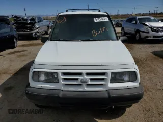 1996 Geo Tracker z VIN 2CNBE1364T6909947, wystawiony jako Copart lot #54411835 z przebiegiem 171 862 mil mil oraz Szkody całkowita. Historia ofert i sprzedaży dostępna na DreamBid. Obrazek 5.