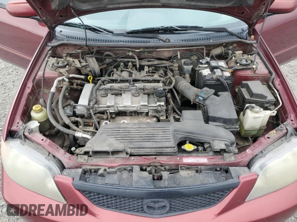 2002 Mazda Protege DX z VIN JM1BJ225320636991, wystawiony jako Copart lot #57915265 z przebiegiem 123 371 mil mil oraz Szkoda całkowita • Salvage title. Historia ofert i sprzedaży dostępna na DreamBid. Obrazek 11.