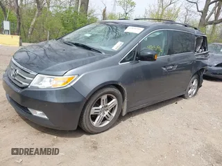 2012 Honda Odyssey Touring with VIN 5FNRL5H99CB028304, listed as a IAAI auction lot 42031916 with 216,185 mi miles and . Bid and sale history available at DreamBid. Image 2.