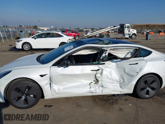 2023 Tesla Model 3 with VIN 5YJ3E1EA2PF582331, listed as a IAAI auction lot 41043858 with 33,601 mi miles and . Bid and sale history available at DreamBid. Image 6.
