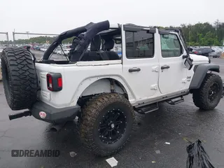 2018 Jeep Wrangler Unlimited Sport with VIN 1C4HJXDG0JW233696, listed as a IAAI auction lot 42523474 with 66,961 mi miles and . Bid and sale history available at DreamBid. Image 4.