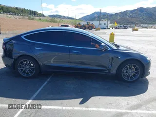2019 Tesla Model 3 Mid Range with VIN 5YJ3E1EA6KF307456, listed as a IAAI auction lot 41944454 with 99,059 mi miles and . Bid and sale history available at DreamBid. Image 12.