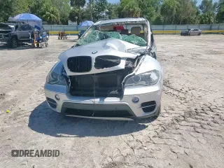 2012 BMW X5 35d with VIN 5UXZW0C51CL668064, listed as a Copart auction lot 62217845 with 140,544 mi miles and Salvage title. Bid and sale history available at DreamBid. Image 14.