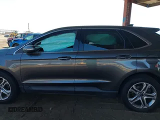 2015 Ford Edge Titanium z VIN 2FMTK3K90FBC12582, wystawiony jako IAAI lot #41860973 z przebiegiem Nie podano mil oraz . Historia ofert i sprzedaży dostępna na DreamBid. Obrazek 13.