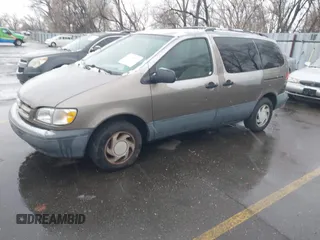 1999 Toyota Sienna LE with VIN 4T3ZF13C9XU164032, listed as a IAAI auction lot 41916673 with 296,628 mi miles and . Bid and sale history available at DreamBid. Image 2.