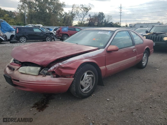 1996 Ford Thunderbird LX with VIN 1FALP62W7TH135632, listed as a Copart auction lot 77134024 with 128,931 mi miles and Salvage Title. Bid and sale history available at carsss.com. Image 1.