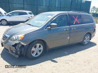 2010 Honda Odyssey Touring z VIN 5FNRL3H90AB085105, wystawiony jako IAAI lot #42142123 z przebiegiem Nie podano mil oraz . Historia ofert i sprzedaży dostępna na DreamBid. Obrazek 2.