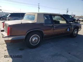 1988 Cadillac Eldorado z VIN 1G6EL115XJU611177, wystawiony jako Copart lot #46526855 z przebiegiem 122 780 mil mil oraz Szkody całkowita. Historia ofert i sprzedaży dostępna na DreamBid. Obrazek 3.