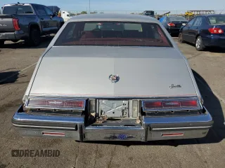 1984 Cadillac Seville z VIN 1G6AS6984EE826325, wystawiony jako Copart lot #77209864 z przebiegiem 26 366 mil mil oraz Tytuł czysty. Historia ofert i sprzedaży dostępna na DreamBid. Obrazek 6.