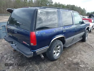 1997 GMC Yukon with VIN 1GKEK13R6VJ715421, listed as a IAAI auction lot 41811398 with 214,735 mi miles. Bid and sale history available at carsss.com. Image 4.