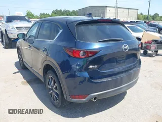 2018 Mazda CX-5 Touring z VIN JM3KFACM7J1410275, wystawiony jako IAAI lot #42248830 z przebiegiem 101 125 mil mil oraz . Historia ofert i sprzedaży dostępna na DreamBid. Obrazek 3.