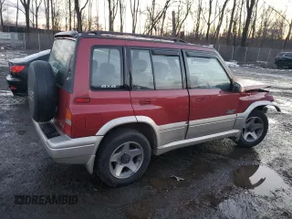 1996 Suzuki Sidekick z VIN JS3TD21V2T4103586, wystawiony jako Copart lot #83492154 z przebiegiem 98 298 mil mil oraz Szkody całkowita. Historia ofert i sprzedaży dostępna na DreamBid. Obrazek 3.