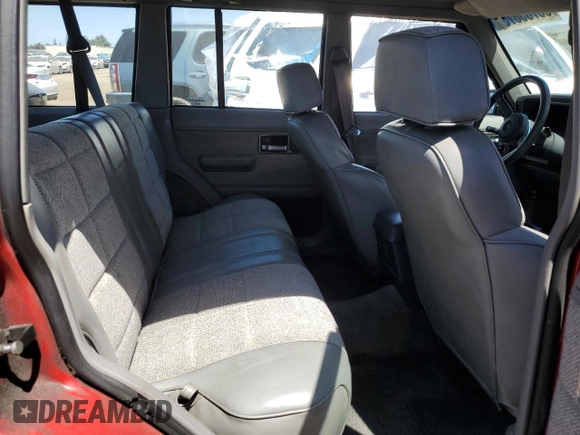 1992 Jeep Cherokee with VIN 1J4FJ58S0NL140995, listed as a Copart auction lot 56705875 with 253,657 mi miles and Salvage title. Bid and sale history available at DreamBid. Image 11.