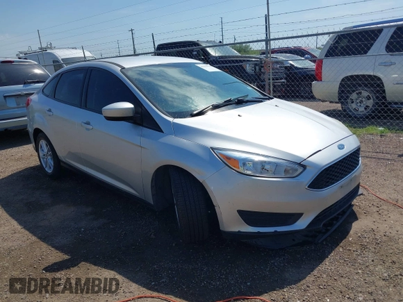 2018 Ford Focus SE z VIN 1FADP3FE0JL321530, wystawiony jako IAAI lot #42275532 z przebiegiem 65 412 mil mil oraz . Historia ofert i sprzedaży dostępna na DreamBid. Obrazek 1.
