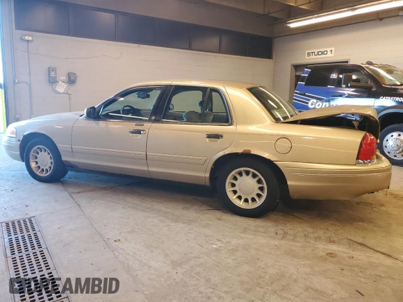 2000 Ford Crown Victoria LX z VIN 2FAFP74WXYX116130, wystawiony jako Copart lot #79441204 z przebiegiem 128 133 mil mil oraz Szkoda całkowita • Salvage title. Historia ofert i sprzedaży dostępna na DreamBid. Obrazek 2.