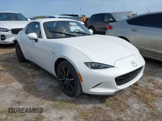 2024 Mazda MX-5 Miata Grand Touring z VIN JM1NDAM77R0606562, wystawiony jako IAAI lot #40614262 z przebiegiem Nie podano mil oraz . Historia ofert i sprzedaży dostępna na DreamBid. Obrazek 1.