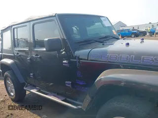 2014 Jeep Wrangler Unlimited Sahara with VIN 1C4BJWEG6EL217945, listed as a IAAI auction lot 42388477 with 61,739 mi miles and . Bid and sale history available at DreamBid. Image 14.