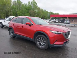 2021 Mazda CX-9 Touring z VIN JM3TCBCY8M0518713, wystawiony jako IAAI lot #41963675 z przebiegiem 47 576 mil mil oraz . Historia ofert i sprzedaży dostępna na DreamBid. Obrazek 1.
