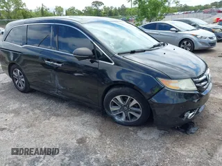2014 Honda Odyssey Touring with VIN 5FNRL5H94EB057499, listed as a IAAI auction lot 41983956 with 158,573 mi miles and . Bid and sale history available at DreamBid. Image 1.