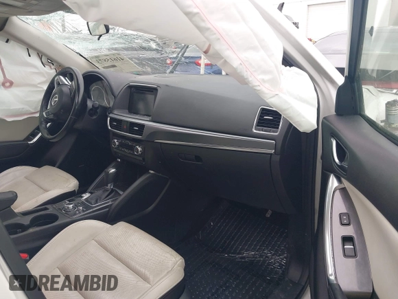 2016 Mazda CX-5 Grand Touring z VIN JM3KE2DY8G0885006, wystawiony jako IAAI lot #41615873 z przebiegiem 118 890 mil mil oraz . Historia ofert i sprzedaży dostępna na DreamBid. Obrazek 5.