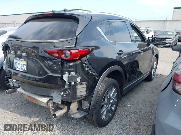 2020 Mazda CX-5 Grand Touring with VIN JM3KFADM3L1819939, listed as a IAAI auction lot 42749920 with 35,407 mi miles and . Bid and sale history available at DreamBid. Image 4.