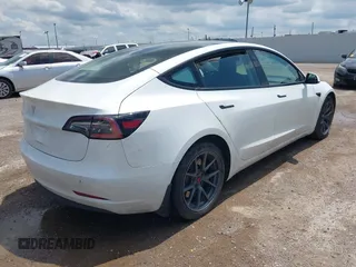 2023 Tesla Model 3 with VIN 5YJ3E1EA5PF407054, listed as a IAAI auction lot 42313770 with 57,621 mi miles and . Bid and sale history available at DreamBid. Image 4.