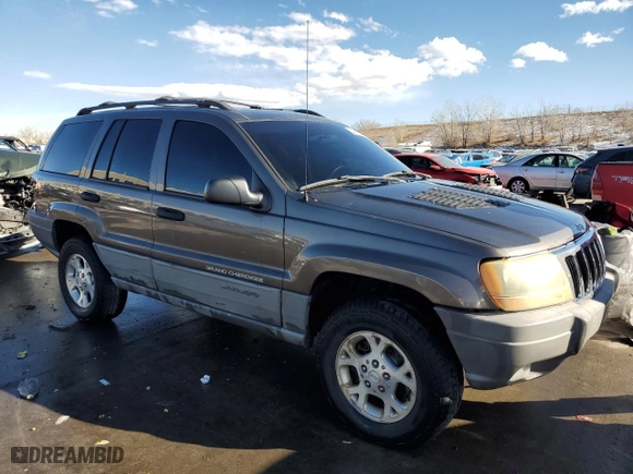1999 Jeep Grand Cherokee Laredo with VIN 1J4GW58N9XC633464, listed as a Copart auction lot 84682454 with 212,738 mi miles and Salvage Title. Bid and sale history available at carsss.com. Image 4.