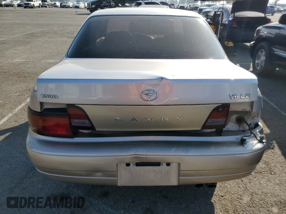 1995 Toyota Camry LE with VIN JT2GK12E7S0107467, listed as a Copart auction lot 83491534 with 112,971 mi miles and Salvage Title. Bid and sale history available at carsss.com. Image 6.