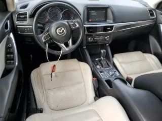 2016 Mazda CX-5 Grand Touring z VIN JM3KE2DY7G0735355, wystawiony jako Copart lot #49438285 z przebiegiem 132 731 mil mil oraz Szkoda całkowita • Salvage title. Historia ofert i sprzedaży dostępna na DreamBid. Obrazek 8.