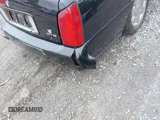 2002 Cadillac DeVille DTS z VIN 1G6KF579320288667, wystawiony jako IAAI lot #42331236 z przebiegiem 71 189 mil mil oraz . Historia ofert i sprzedaży dostępna na DreamBid. Obrazek 21.