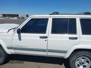 2000 Jeep Cherokee z VIN 1J4FF48S3YL236054, wystawiony jako IAAI lot #42217775 z przebiegiem 192 826 mil mil oraz . Historia ofert i sprzedaży dostępna na DreamBid. Obrazek 14.