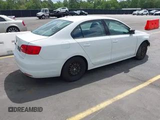 2014 Volkswagen Jetta Sedan S with VIN 3VW2K7AJ6EM334635, listed as a IAAI auction lot 42151738 with 142,923 mi miles. Bid and sale history available at carsss.com. Image 4.