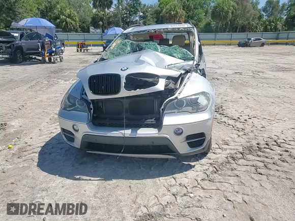 2012 BMW X5 35d with VIN 5UXZW0C51CL668064, listed as a Copart auction lot 62217845 with 140,544 mi miles and Salvage title. Bid and sale history available at DreamBid. Image 14.