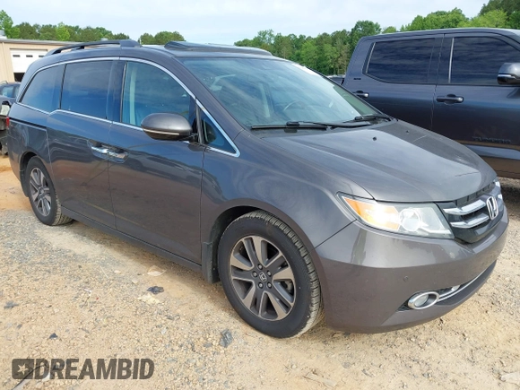 2015 Honda Odyssey Touring Elite z VIN 5FNRL5H97FB060981, wystawiony jako IAAI lot #42289631 z przebiegiem 160 947 mil mil oraz . Historia ofert i sprzedaży dostępna na DreamBid. Obrazek 1.