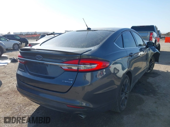 2018 Ford Fusion SE z VIN 3FA6P0LU8JR116073, wystawiony jako IAAI lot #41773037 z przebiegiem 100 864 mil mil oraz . Historia ofert i sprzedaży dostępna na DreamBid. Obrazek 4.