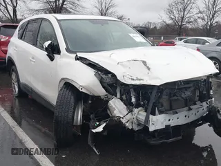 2016 Mazda CX-5 Touring z VIN JM3KE4CYXG0804794, wystawiony jako IAAI lot #41058872 z przebiegiem 79 295 mil mil oraz . Historia ofert i sprzedaży dostępna na DreamBid. Obrazek 1.
