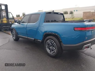 2025 Rivian R1T Adventure z VIN 7FCTGBAA9SN035986, wystawiony jako IAAI lot #41510257 z przebiegiem 2 102 mil mil oraz . Historia ofert i sprzedaży dostępna na DreamBid. Obrazek 3.