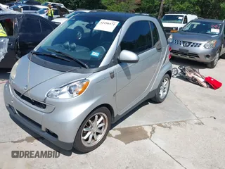 2008 Smart fortwo Pure with VIN WMEEJ31X68K106096, listed as a IAAI auction lot 42456471 with 92,074 mi miles and . Bid and sale history available at DreamBid. Image 2.
