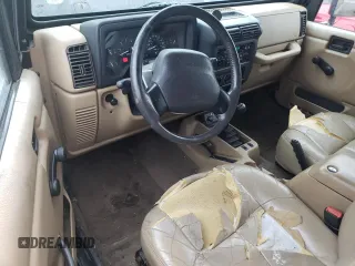 2000 Jeep Wrangler Sahara z VIN 1J4FA59S2YP714136, wystawiony jako Copart lot #57635845 z przebiegiem 178 075 mil mil oraz Czysty tytuł • Clean title. Historia ofert i sprzedaży dostępna na DreamBid. Obrazek 8.