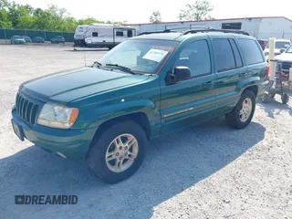 1999 Jeep Grand Cherokee Limited z VIN 1J4GW68N5XC630910, wystawiony jako IAAI lot #42380978 z przebiegiem 188 300 mil mil oraz . Historia ofert i sprzedaży dostępna na DreamBid. Obrazek 2.
