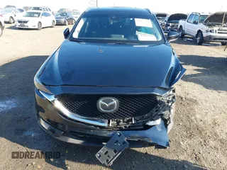 2020 Mazda CX-5 Grand Touring with VIN JM3KFBDM0L0790508, listed as a IAAI auction lot 41883319 with 114,398 mi miles and . Bid and sale history available at carsss.com. Image 6.