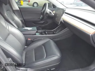 2019 Tesla Model 3 Mid Range with VIN 5YJ3E1EA3KF415601, listed as a IAAI auction lot 42125393 with 150,220 mi miles and . Bid and sale history available at carsss.com. Image 5.