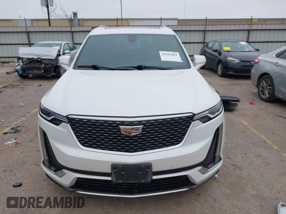 2021 Cadillac XT6 Premium Luxury z VIN 1GYKPCRSXMZ169206, wystawiony jako IAAI lot #41581841 z przebiegiem 64 789 mil mil oraz . Historia ofert i sprzedaży dostępna na DreamBid. Obrazek 12.