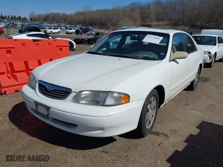 1998 Mazda 626 DX with VIN 1YVGF22CXW5702980, listed as a IAAI auction lot 41778063 with 104,672 mi miles. Bid and sale history available at carsss.com. Image 2.