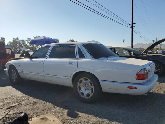 2001 Jaguar XJ VDP with VIN SAJDA24C11LF28715, listed as a Copart auction lot 65246334 with 107,965 mi miles and Salvage Title. Bid and sale history available at carsss.com. Image 2.