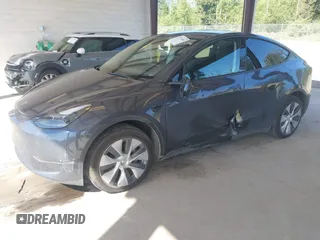 2023 Tesla Model Y Long Range with VIN 7SAYGAEE4PF906577, listed as a IAAI auction lot 42174987 with 13,260 mi miles and . Bid and sale history available at DreamBid. Image 2.