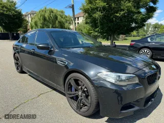 2015 BMW M5 with VIN WBSFV9C56FD595096, listed as a Copart auction lot 76574074 with 61,779 mi miles and Salvage Title. Bid and sale history available at carsss.com. Image 1.