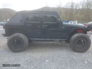 2013 Jeep Wrangler Unlimited Sport with VIN 1C4BJWDG5DL504368, listed as a IAAI auction lot 41941659 with 117,838 mi miles. Bid and sale history available at carsss.com. Image 13.