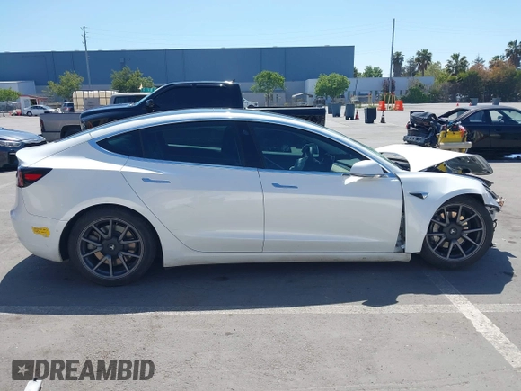2020 Tesla Model 3 Standard Range Plus with VIN 5YJ3E1EAXLF590591, listed as a IAAI auction lot 42140338 with 79,342 mi miles and . Bid and sale history available at DreamBid. Image 14.