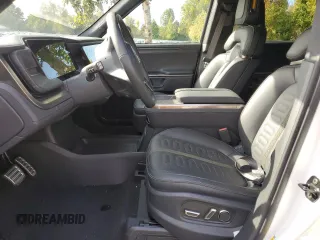 2024 Rivian R1S Adventure z VIN 7PDSGABAXRN035766, wystawiony jako Copart lot #77481034 z przebiegiem 6 590 mil mil oraz Szkoda całkowita • Salvage title. Historia ofert i sprzedaży dostępna na DreamBid. Obrazek 7.